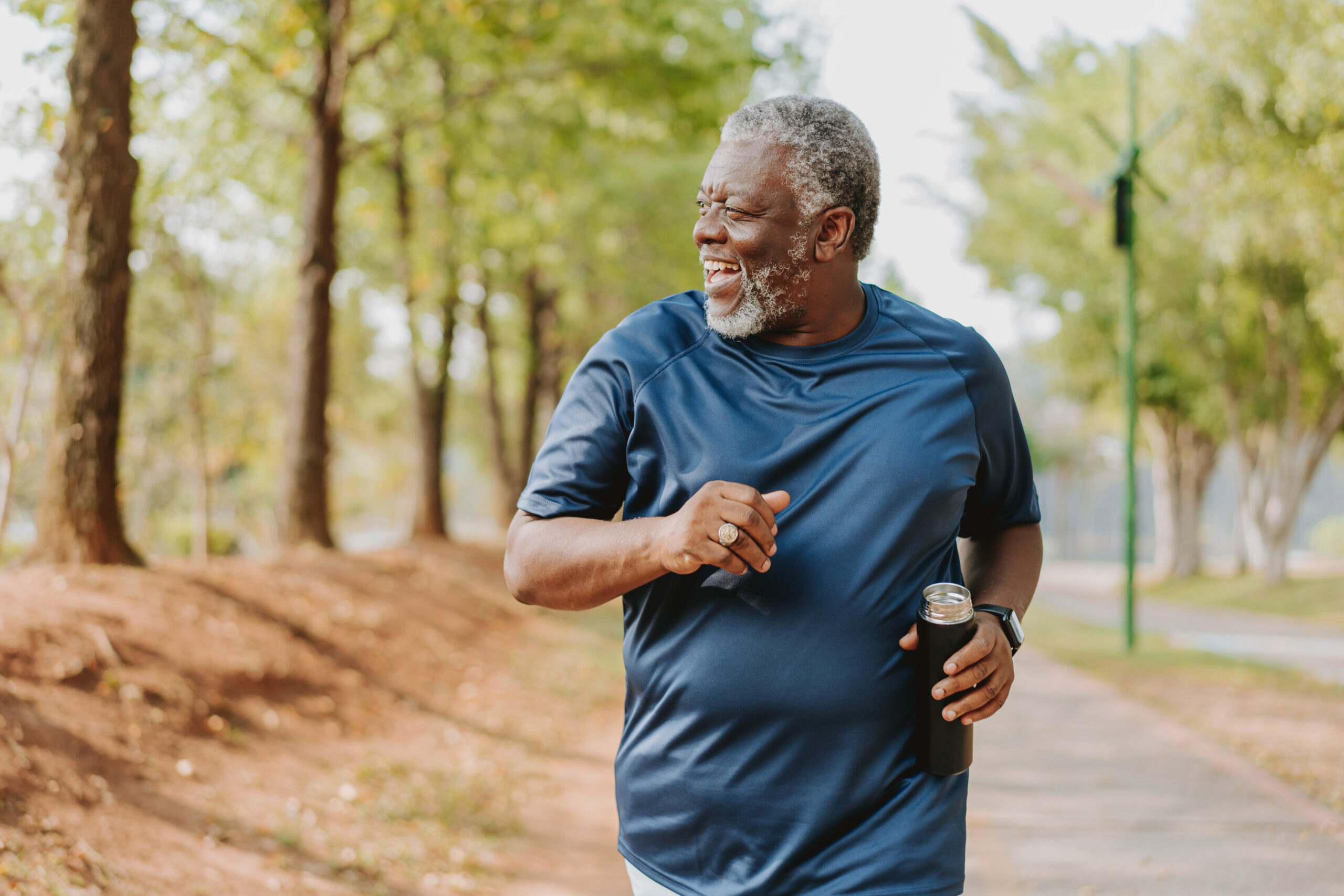 Senior man smiling and running